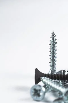 Metal screws stand upright, sharp and gleaming Stock Photos