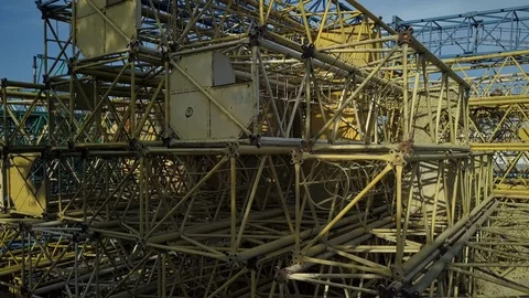 Metal sections of the dismantled construction crane in the street. Construction Stock Footage 89503616