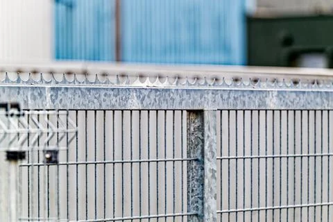 Metal security fence with sharp spikes for protection and safety in industr.. Stock Photos