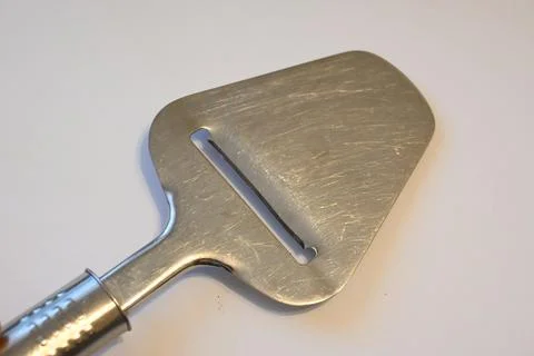 Metal slicer on a white surface Foto stock