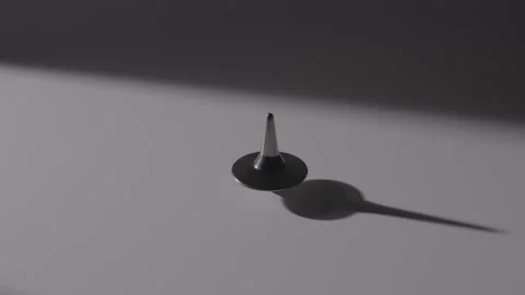 Metal Spinning Top Rotating on Smooth White Surface, Close-up Video stock 336549748