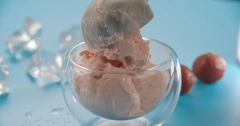 Metal spoon put ball of ice cream in glass. 4K slow motion video Stock Footage 112193770