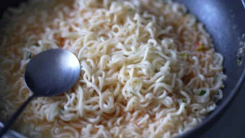 A metal spoon resting beside the noodles. Stock Footage 344704341