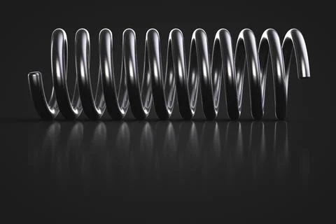 Metal spring close up. Dark background. Stock-Fotos