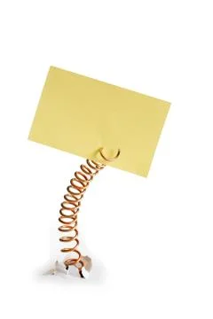 Metal spring with yellow note pad Stock Photos