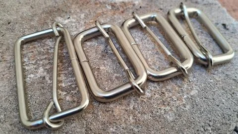 Metal strap buckles for bags. Rectangular hardware sliders for leather craft and Stock Photos