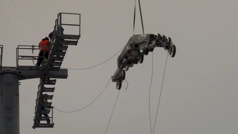 Metal structure hangs on cable helicopte two meters from platform support. Stock Footage 106168967