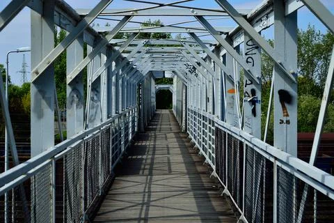 Metal structure of a pedestrian bridge. Sky. Day. Stock Photos
