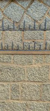 Metal Structure on Stone Wall Stock Photos
