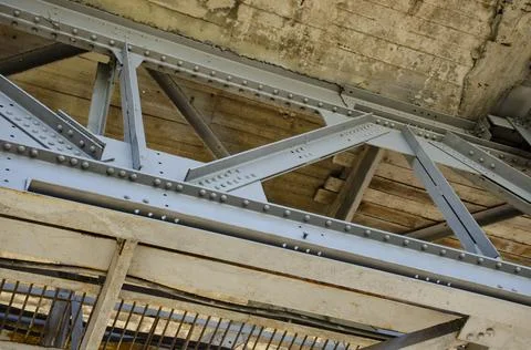 Metal structures under the bridge, large metal bridge over water. View from Stock Photos