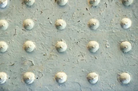 Metal surface aged by time with rivets as a background motif Fotos Stock