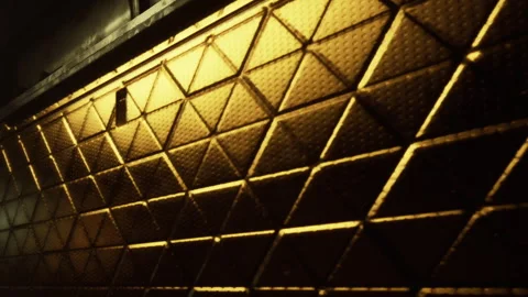 Metal surface with diamond pattern under warm light in a dark space Stock Footage 344314718