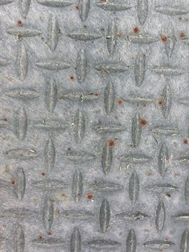 Metal surface with embossed diamond pattern Stock Photos