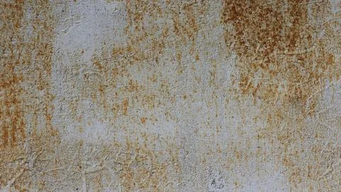 The metal surface has rust and worn gray, light blue paint. Stock Photos