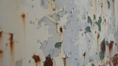 Metal surface with peeling paint and rust grungy background texture slow motion Stock Footage 252083342