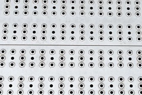Metal surface perforated pattern many round holes gray base design industrial 스톡 사진