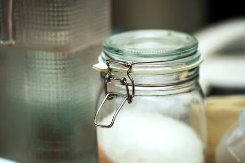 Metal swing latch lock securing a glass jar filled with sugar. The lock add.. Stock Photos