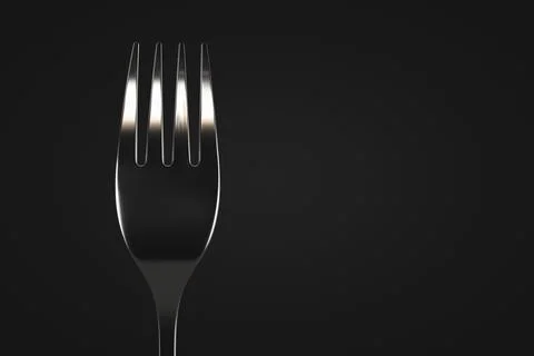 Metal table fork close-up. Dark background. Copy space. Stock Photos
