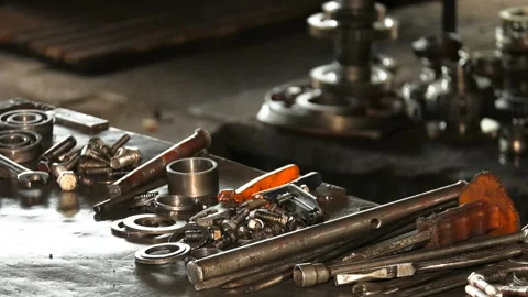 On the metal table lie the tools and spare parts of the car mechanic. Stock Footage