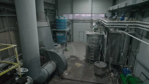Metal tanks connected with pipelines in empty workshop Stock Footage 259563279