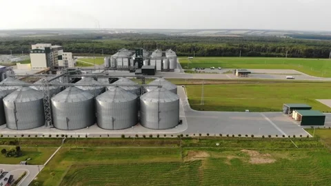 Metal tanks of the elevator. Grain drying complex in the open air. Commercial Stock Footage 194192607