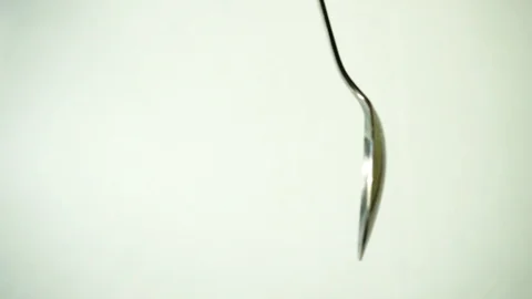 Metal teaspoon on white background. 1 Stock Footage 97876129