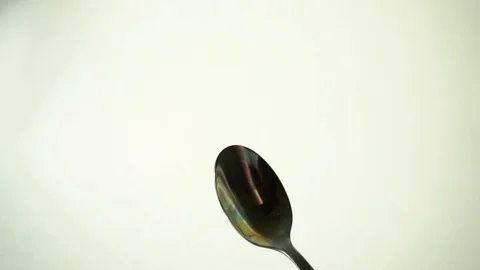 Metal teaspoon on white background. 4 Stock Footage 97876136