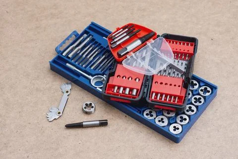 Metal thread cutting tap and die set with handle, drill bits, and gauges ar.. Stock Photos