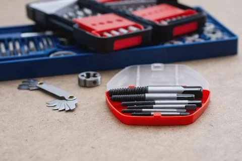 Metal thread cutting tap and die set with handle, drill bits, and gauges ar.. Stock Photos