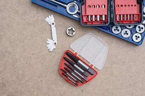 Metal thread cutting tap and die set with handle, drill bits, and gauges ar.. Stock Photos