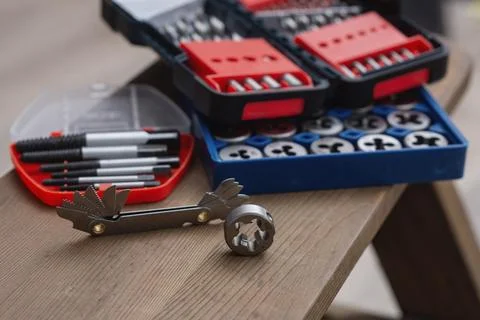 Metal thread cutting tap and die set with handle, drill bits, and gauges ar.. Stock Photos