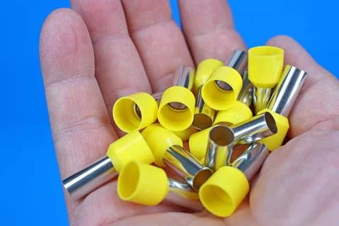 Metal tips with a plastic base for mounting on stranded copper wires. Stock Photos