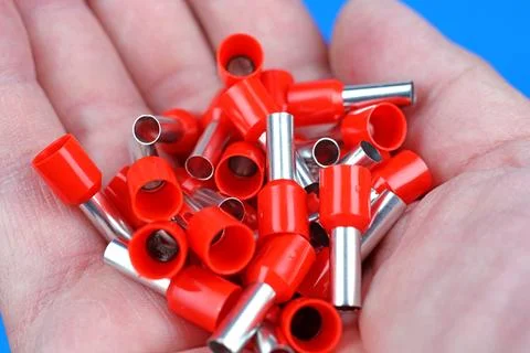 Metal tips with a plastic base for mounting on stranded copper wires. Stock Photos