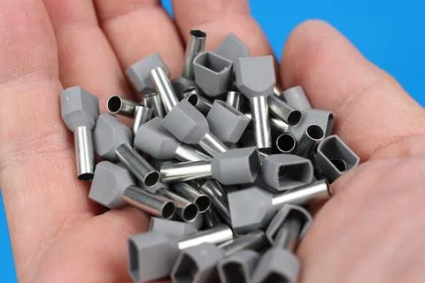 Metal tips with a plastic base for mounting on stranded copper wires. Stock Photos