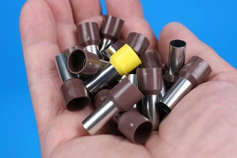 Metal tips with a plastic base for mounting on stranded copper wires. Stock Photos