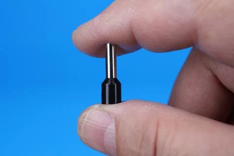 Metal tips with a plastic base for mounting on stranded copper wires. Stock Photos