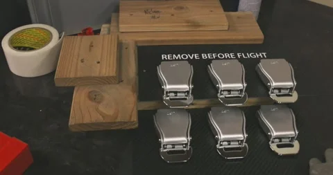 Metal Toggle Latches in Two Rows, Dark Workshop Table, Close Up Shot Видео 340305450