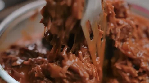 Metal Tongs Mixing Pulled Beef with Tomato Sauce Stock Footage 314624860