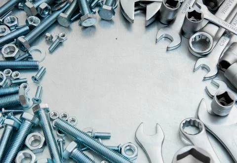 Metal tools and fixing elements on the scratched metal background. Stock Photos