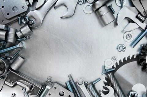 Metal tools and fixing elements on the scratched metal background. 스톡 사진