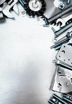 Metal tools and fixing elements on the scratched metal background. 스톡 사진