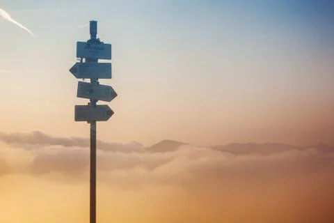 Metal trail pointer on top of the mountain. Stock Photos
