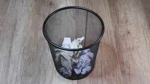 Metal trash bin being filled with waste paper Видео 268014124