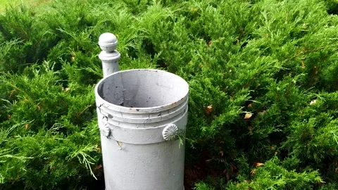 A metal trash can in the park. An old trash can, a container for waste disposal. Stockbeeldmateriaal 343411985