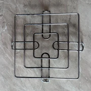 Metal trivet on marble surface Stock-Fotos