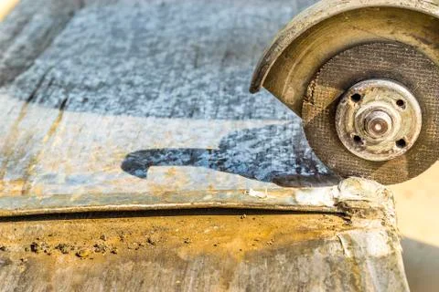 A metal vent is being cut by a sharp grinder Stock Photos
