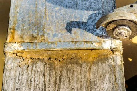 A metal vent is being cut by a sharp grinder Stock Photos