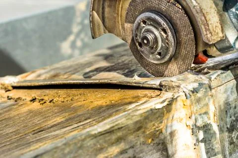 A metal vent is being cut by a sharp grinder Stock Photos