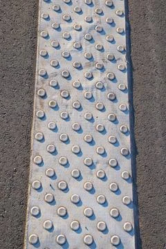 Metal walkway surface with textured pattern on urban street in Neuss, Germany Stock Photos