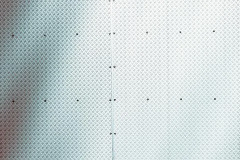 Metal wall with rivets, background, texture. Stock Photos